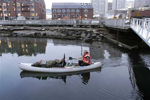 Michael Richard Smith pilots his canoe in Boston Harbor on Tuesday.