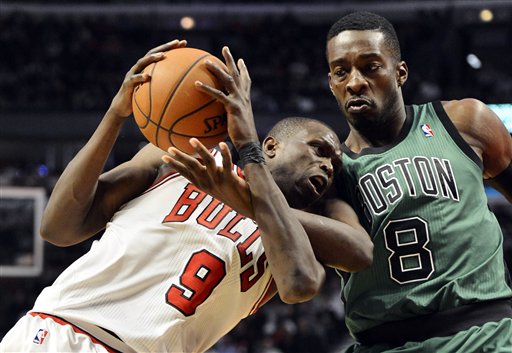 Boston Celtics forward Jeff Green (8) fouls Chicago Bulls forward Luol Deng on Deng's drive to the basket during the third quarter of an NBA basketball game, Tuesday, Dec. 18, 2012 in Chicago. The Bulls won 100-89. (AP Photo/Brian Kersey)