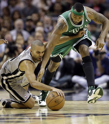 San Antonio Spurs' Tony Parker, left, of France, and Boston Celtics' Chris Wilcox, right, scramble for the loose ball during the fourth quarter of an NBA basketball game, Saturday, Dec. 15, 2012, in San Antonio. San Antonio won 103-88. (AP Photo/Eric Gay)