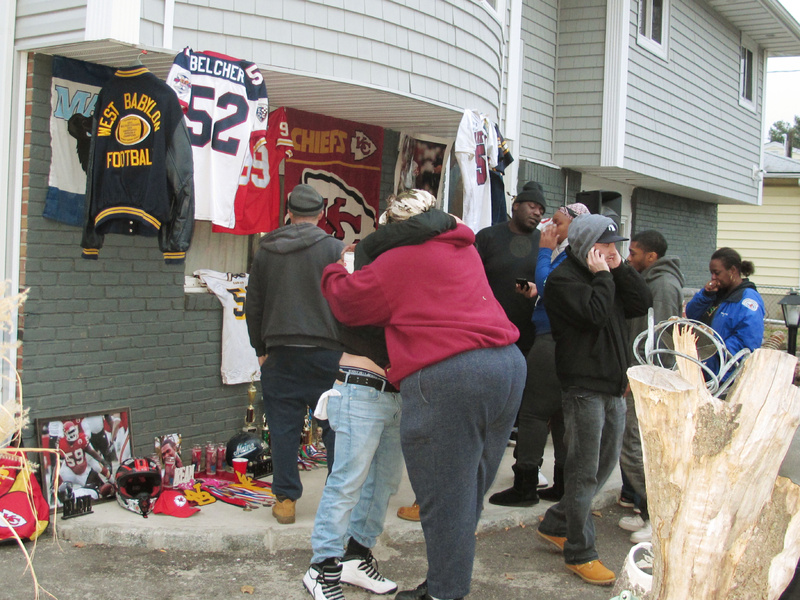 Friends and relatives of Jovan Belcher, the former University of Maine player and linebacker for the Kansas City Chiefs, grieve Saturday outside the Belcher family home in West Babylon, N.Y.
