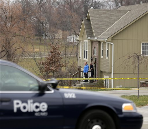 Investigators stand outside an Independence, Mo., house where police say Kansas City Chiefs linebacker Jovan Belcher fatally shot his girlfriend Saturday before driving to the NFL football team's training facility and shooting himself.