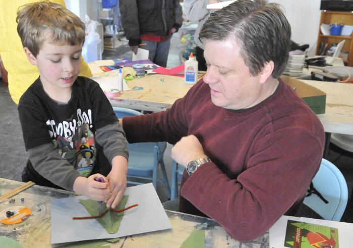 James Stewart, 44, of Oakland, and his son, Lukas, 6, work on making a Christmas tree pop-up card during a holiday card-making workshop at Common Street Arts in Waterville on Saturday. The workshop was sponsored by Common Street Arts and the Colby College Art Museum.