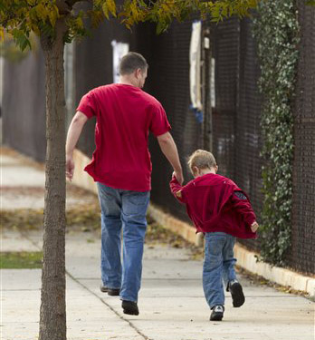 Tom Fico holds hands with his son Lucas, 5, as they skip on their way to kindergarten in Burbank, Calif., on Monday. New York University child and adolescent psychiatry professor Glenn Saxe says: "If there is any time to be a little more flexible about routines and rules in support of our children, it is now."