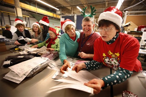 LL Bean employees wear Santa Claus hats and antlers as they celebrate the holiday spirit while working in the company's order fulfillment center onThursday in Freeport. The outdoors store is making its final push to get things shipped in time for Christmas.