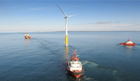 In this June 2009 publicity photo, tugboats haul the demonstration Hywind floating wind turbine out to sea off of the coast of Norway for testing. The company is proposing to erect similar turbines in the deep waters of the Gulf of Maine.