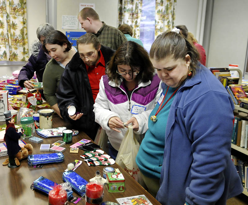 People line up for gifts Tuesday during a Christmas celebration at the Prince of Peace Lutheran Church in Augusta. Volunteers donated cooked meals and presents for guests.