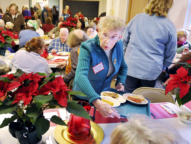 Phyllis Tessman serves pie Tuesday, during a Christmas dinner at Prince of Peace Lutheran Church in Augusta. Several guests ate meals prepared by volunteers at the church.