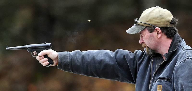 Jeffrey Fortin, of Augusta, fires a pistol Saturday, at a range in Augusta. Fortin, who recently purchased an assault rifle, said the recent surge in gun sales is from fear. "Everybody is scared," Fortin said.
