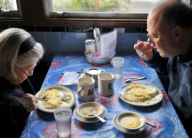 Martin Weiss and his mother, Miriam, sample latkes on Sunday at the A1 Diner in Gardiner. A special menu was served at the restaurant, which celebrated the arrival of Hanukkah, including the potato pancakes that are served with a side of applesauce.