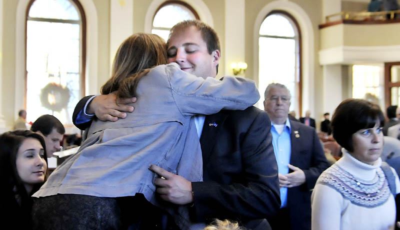 Matt Pouliot, R-Augusta, hugs his mother, Lisa Pouliot, Wednesday before taking the oath of office in the House of Representatives in Augusta.