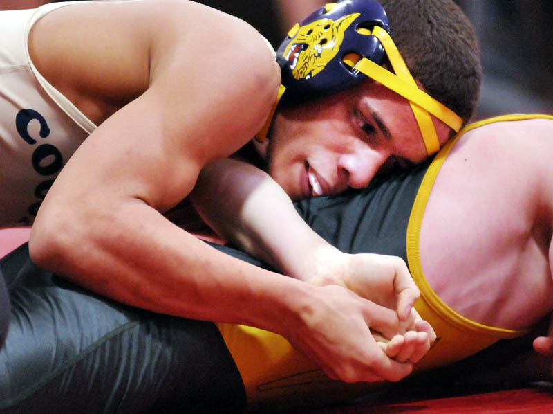 Khalil Newbill of Mt. Blue High School, left, attempts to pin Oxford Hills Comprehensive High School’s Jon Hankey Saturday at the Cony Duels in Augusta. Newbill won the match 9-0.