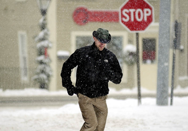 Dr. Nate Murray-James runs back to his Hallowell office on Thursday, after running a quick errand between seeing patients at Hallowell Family Practice. Most offices and schools were closed during the storm that dumped up to a foot of snow across Maine.