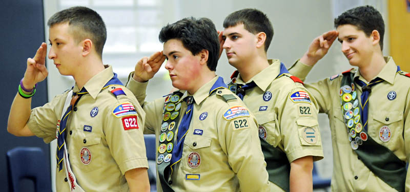 Nick Neuhaus, left, Tucker Whitman, Tommy Lanphear and Alec Daigle salute the flag Sunday, during their Eagle Court of Honor by Boy Scout Troop 622 in Manchester. The teenagers were recognized at the Manchester Elementary School after each completed lengthy community projects and were elevated to the ranks of Eagle Scout.