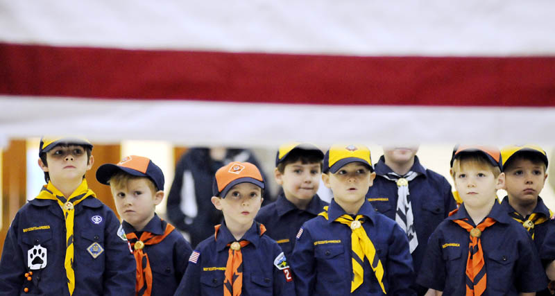 Members of Cub Scout Pack 222, of Palermo, observe soliders with the Maine Army National Guard's Maine Military Funeral Honors Program folding the U.S. flag Tuesday, at the Augusta State Armory. After watching the soldiers present the colors, the Scouts practiced proper flag etiquette under the supervision of the Guardsmen, who provide honor burials for veterans.