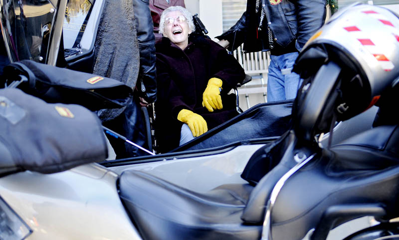 Olive Taverner laughs Wednesday after dismounting the sidecar of a motorcycle following, a ride in 20 degree F temperatures through Augusta. The 91-year-old said the bike ride, courtesy of the Combat Vets Motorcycle Association, was on the bucket list she composed upon retiring as a teacher in 1986. The resident of Gray Birch Long Term Care in Augusta said the only wish she has to left to complete on the list is a helicopter ride. The side car journey was, she said, "just wonderful."