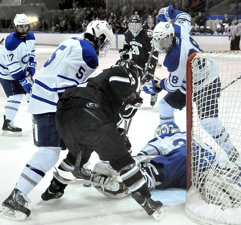 Colby College goalie Jordan Nathan, 30, tries to make a save as teammates Brendan Cosgrove, 5, left, and Scott Harff, 28, right, scrap for the puck with Bowdoin College's Harry Matheson, 12, center tries to score in the first period at Alfond Arena at Colby College in Waterville on Saturday.