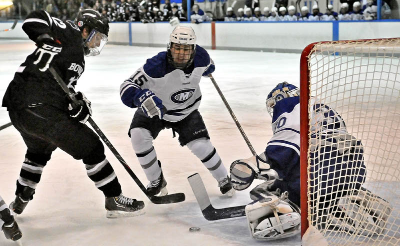 Bowdoin College's Harry Matheson, 12, left, takes a shot on Colby College goalie Jordan Nathan, 30, right, as Jack Bartlett, 15, center, defends in the first period at Alfond Arena at Colby College in Waterville on Saturday.