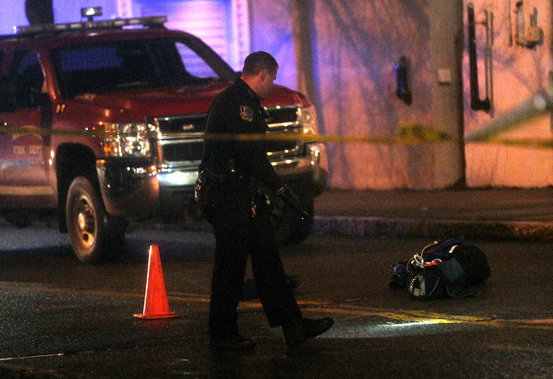 Staff photo by Michael G. Seamans Police investigate the scene where a man was shot on The Concourse late Tuesday night in Waterville.