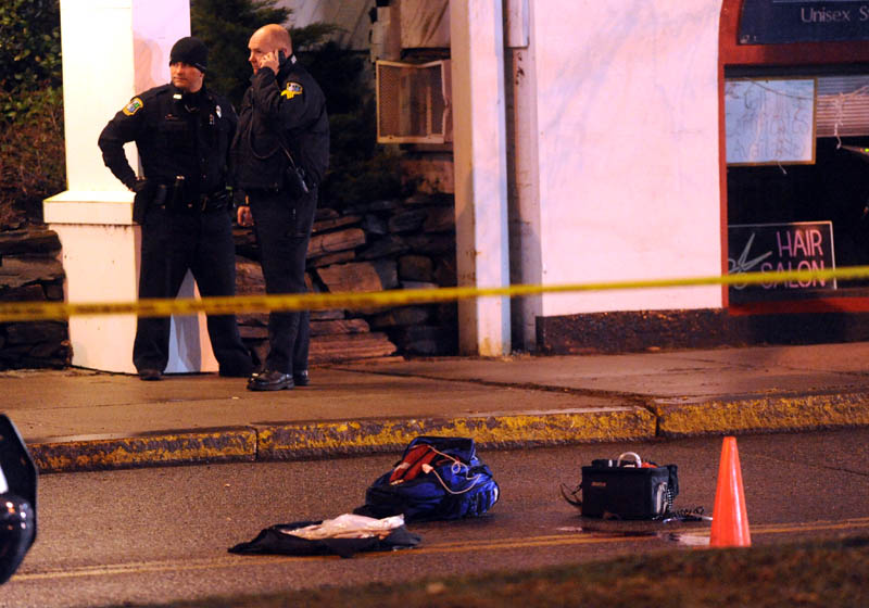 Police investigate the scene where a man was shot on The Concourse late Tuesday night in Waterville.