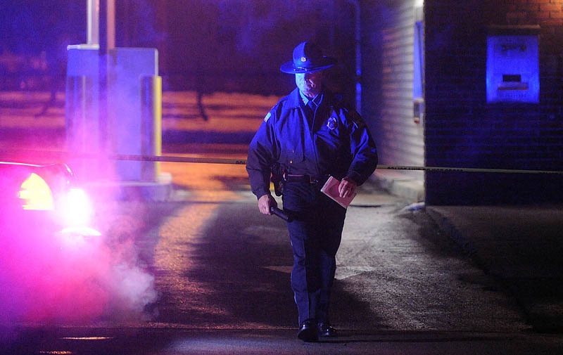 Michael Emmons, Skowhegan police chief, emerges from the drive-through teller bay at Franklin Savings Bank on Madison Avenue in Skowhegan Thursday, Dec. 13, 2012, while investigating a robbery.