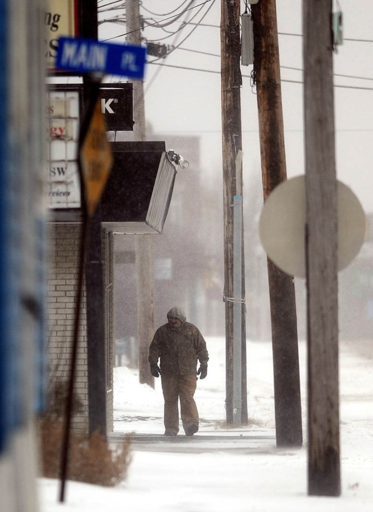 A man battles through the snow on a walk down South Main Street in Waterville on Thursday.