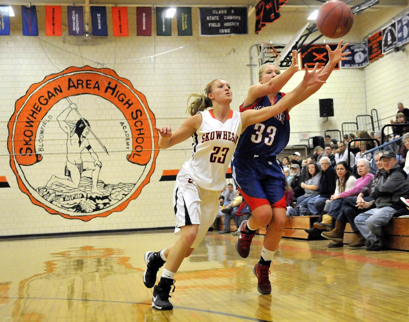 GOOD EFFORT: Skowhegan Area High School’s Adriana Martineau, left, tries to steal a pass intended for Messalonskee High School’s Mikayla Turner in the first quarter of the Eagles’ 56-46 win Saturday in Skowhegan.