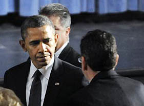 President Barack Obama greets Gov. Dannel Malloy during his arrival at the start of an interfaith vigil for the victims of the Sandy Hook Elementary School shooting on Sunday, Dec. 16, 2012 at Newtown High School in Newtown, Conn. Five days before the U.S. goes over the "fiscal cliff," a deal between Republicans and Democrats appears far away. (AP Photo/The Hartford Courant, Stephen Dunn, Pool)