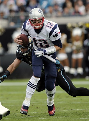 New England Patriots quarterback Tom Brady (12) is pressured by Jacksonville Jaguars outside linebacker Russell Allen (50) during the first half of an NFL football game, Sunday, Dec. 23, 2012, in Jacksonville, Fla. The Patriots beat the Jaguars 23-16.(AP Photo/Stephen Morton)