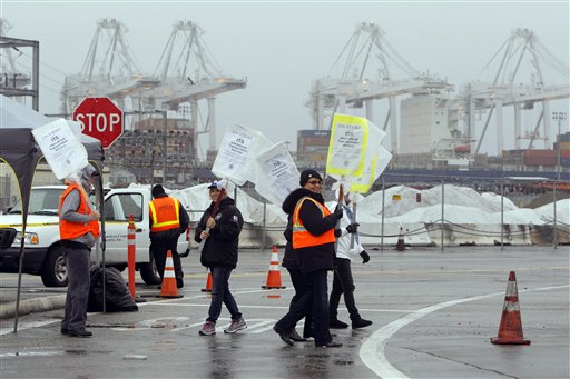 Striking workers man the picket line at the Port of Long Beach last Friday in Long Beach, Calif.