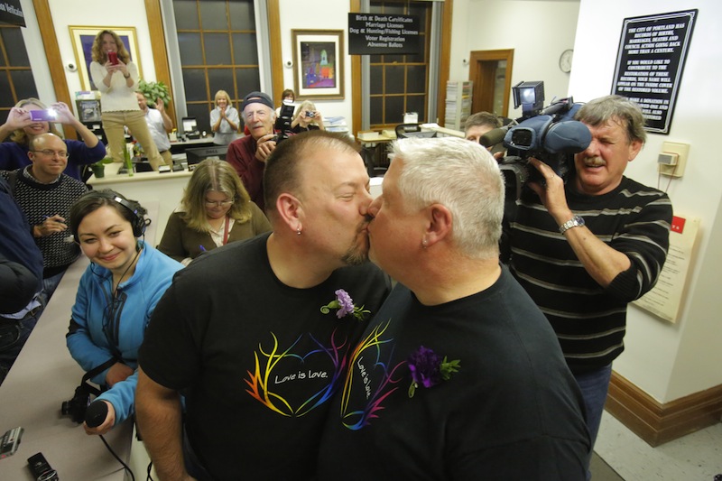 Steve Bridges, left, and Michael Snell, both of Portland, kiss after being the first couple to be married at Portland City Hall on Saturday morning, December 29, 2012.