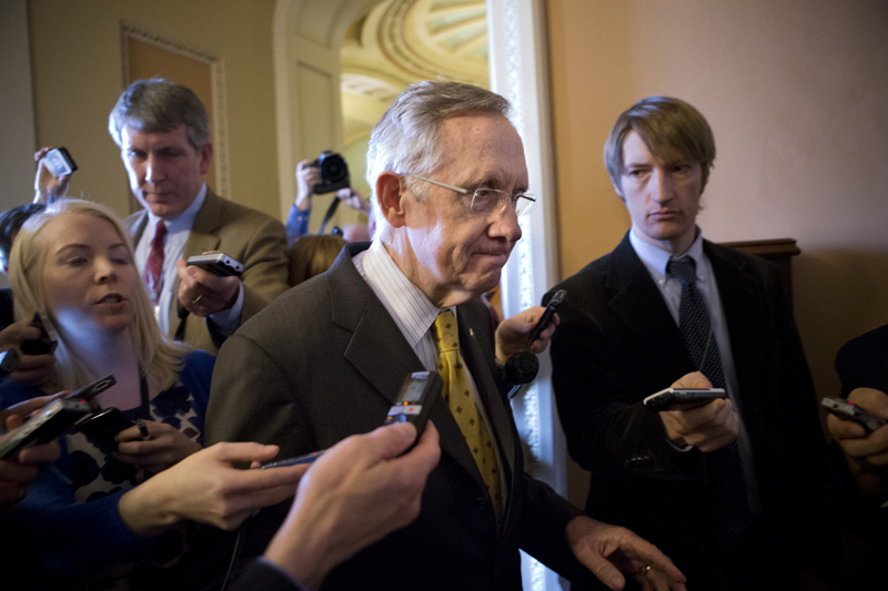 Senate Majority Leader Harry Reid, D-Nev., retreats to a closed-door meeting with fellow Democrats as he and Senate Minority Leader Mitch McConnell, R-Ky., work to negotiate a legislative path to avoid the so-called "fiscal cliff," at the Capitol in Washington on Sunday.