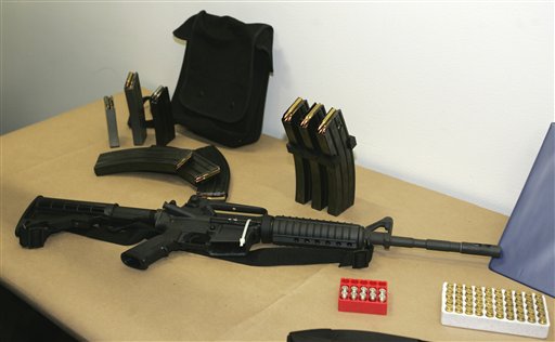 A Bushmaster AR-15 semi-automatic rifle and ammunition are displayed at the police headquarters in Seattle. The maker of the Bushmaster rapid-fire weapon was put up for sale on Tuesday as investors soured on the gun business.