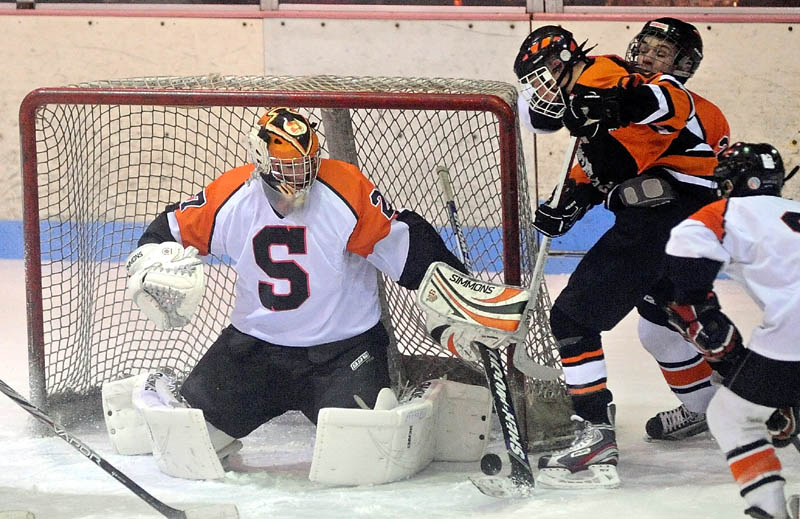 Skowhegan High School goalie, Sam Edmondson makes a save in the first period Wednesday at Sukee Arena in Winslow.