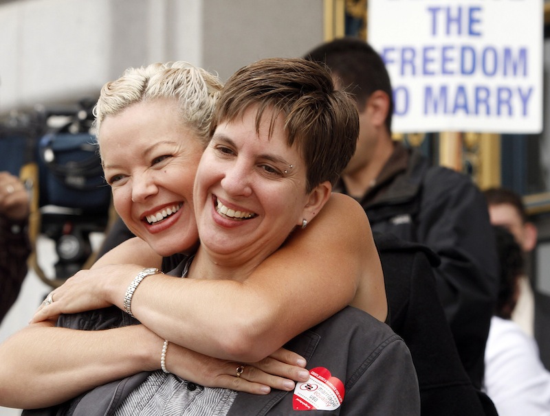 In this file photo from Aug. 12, 2010, gay couple Tara Walsh, left, and Wen Minkoff embrace outside City Hall in San Francisco. The U.S. Supreme Court decided Friday, Dec. 7, 2012, to hear the appeal of a ruling that struck down Proposition 8, the state’s measure that banned same sex marriages. The highly anticipated decision by the court gives the justices the chance to say by late June whether gay Americans have the same constitutional right to marry as heterosexuals. (AP Photo/Ben Margot)