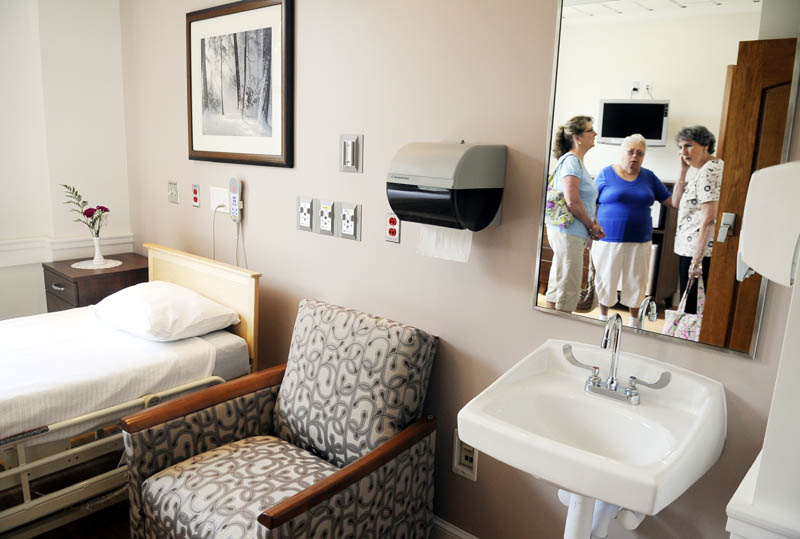 CARING: Therese Lacasse, right, Betty Dutil, center, and Irene MacNaughton inspect a room Tuesday at the new Hospice and Pallative Care ward at the Togus VA. Dutil's husband, Lacasse and MacNaughton's brother, received care at Togus while as he died.