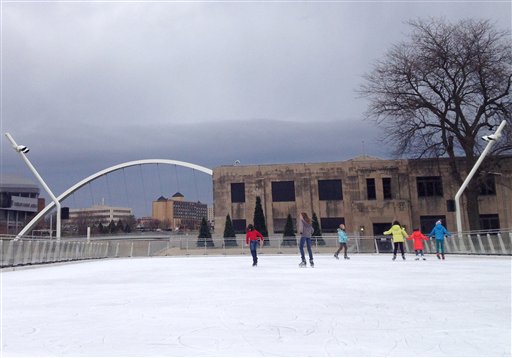 Skaters make their way across ice at Brenton Skating Plaza in downtown Des Moines on Thursday. Iowa's capital city is expecting clear skies Friday.