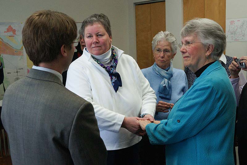 Cathy Meaney, 57, and Anne Merrifield, 73, take marriage vows at Brunswick Town Hall Saturday Town councilor Ben Tucker officiates the wedding. Their friend, Elaine Mower, of Brunswick was a witness.