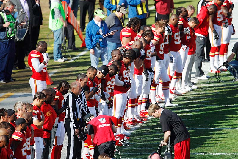 Kansas City Chiefs players stand for a moment of silence before the start of Sunday's game against the Carolina Panthers at Arrowhead Stadium in Kansas City, Mo. The Chiefs had a moment of silence for all victims of domestic abuse before the national anthem on Sunday.
