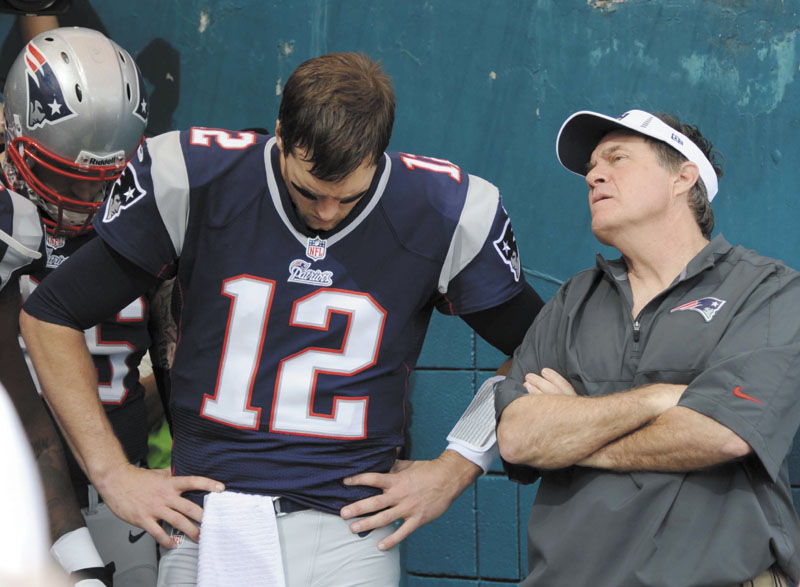 HELP ON THE WAY: New England quarterback Tom Brady, left, and head coach Bill Belichick could see a few important players return to the field when the Patriots play the Houston Texans on Monday. Guard Logan Mankins and defensive end Chandler Jones may play.