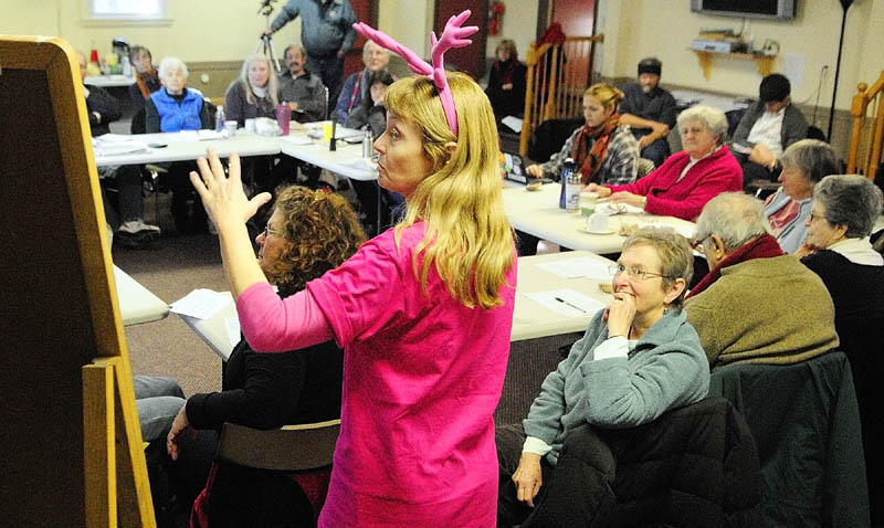 Lisa Savage, standing, facilitates a meeting of activists held to discuss the fiscal cliff on Saturday in Augusta.