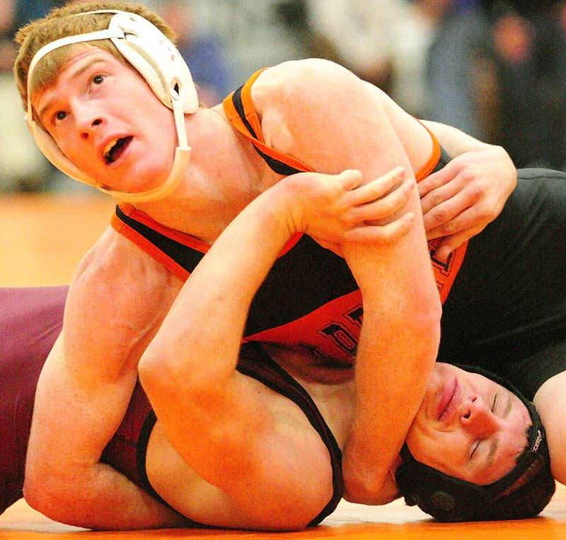 Staff photo by Joe Phelan Gardiner Dan Del Gallo beats Monmouth Academy Stewart Buzzell on a technical fall during the 145-pound championship match of the Tiger Invitational on Saturday in the James A. Bragoli Memorial Gym in Gardiner.