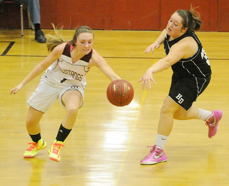 Monmouth senior guard Danielle Bumann, left, tries to regain control of the ball after Hall-Dale freshman forward Molly French knocked it away from her Thursday at Monmouth Academy. The Mustangs won, 59-55. For local roundup, see C3.