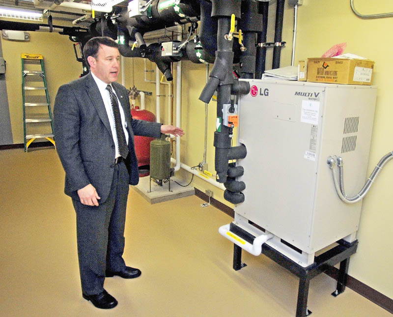 Executive Vice President Andrew E. Silsby talks about the heat pump system during a tour of the new Kennebec Savings Bank branch, at the corner of Main and Northern Avenues in Farmingdale, on Wednesday.