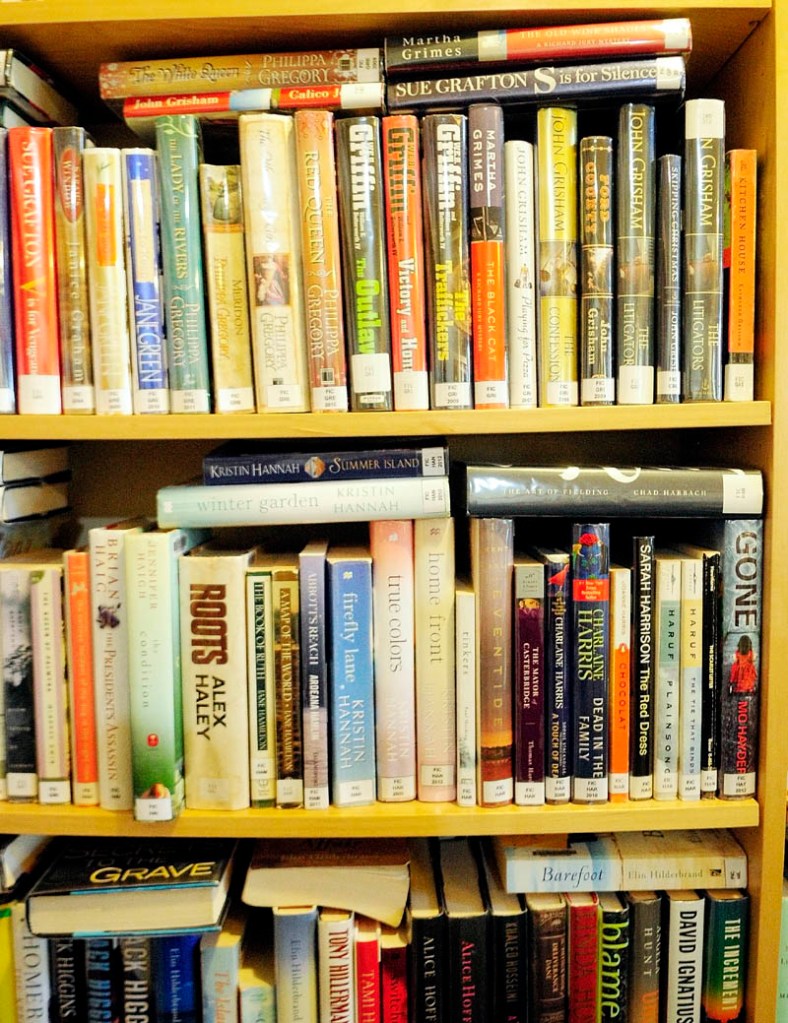 Books are horizontally stacked to fit more in the shelves, on Thursday at the Belgrade library.