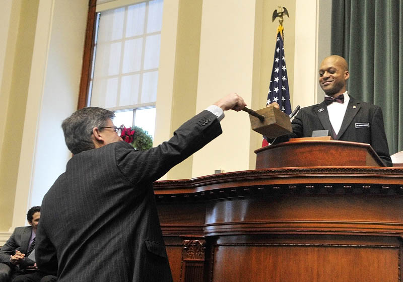 Maine Electoral College Secretary Roy Gedat, left, holds the ballot box to collect Maine Electoral College President Craig Hickman's vote on Monday, in the House chamber of the State House in Augusta. Hickman, a Democratic state representative from Winthrop, along with fellow Electoral College members Diane Denk, of Kennebunk, Marianne Stevens, of Kingfield, and Jill Duson, of Portland, cast four votes for Barack Obama as U.S. president and Joe Biden as vice president.