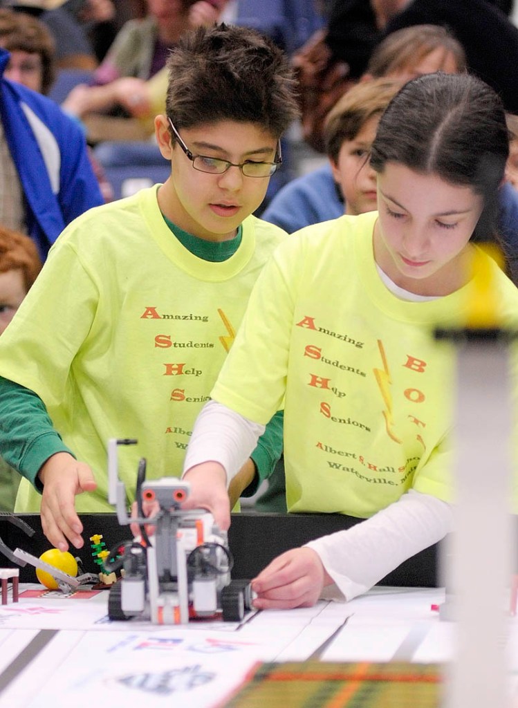 Alex Millones, left, and Abigail Bloom, from the Albert S. Hall School in Waterville, set up their team's robot to compete at the 13th annual Maine First LEGO League Championship on Saturday, at the Augusta Civic Center.