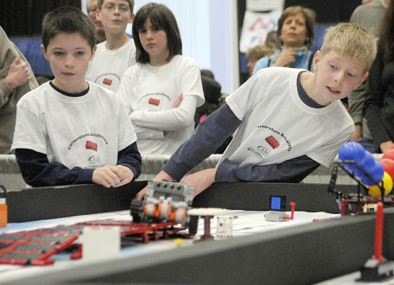 Preston Moody, left, and Isaac Lawrence, from the Cornerstone Community Church team in Winthrop, watch their team' s robot compete at the 13th annual Maine First LEGO League Championship on Saturday, at the Augusta Civic Center.