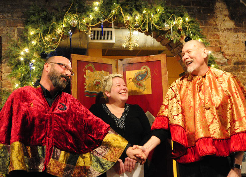 Brian Kaufman, left, and Martin Swinger, right, sing "Stuck On You" from the musical "Whoop-Dee-Doo" to each other during their wedding on Saturday at Slates Restaurant in Hallowell. Their wedding was officiated by Hallowell Mayor Charlotte Warren, center. Town clerks in central Maine reported only a handful of same-sex couples seeking marriage licenses on Monday, the first business day after Maine's same-sex marriage law went into effect, on Saturday. Some municipal offices in Maine, including Gardiner, Hallowell and Winthrop, opened on Saturday to accommodate marriage licenses and other municipal business.