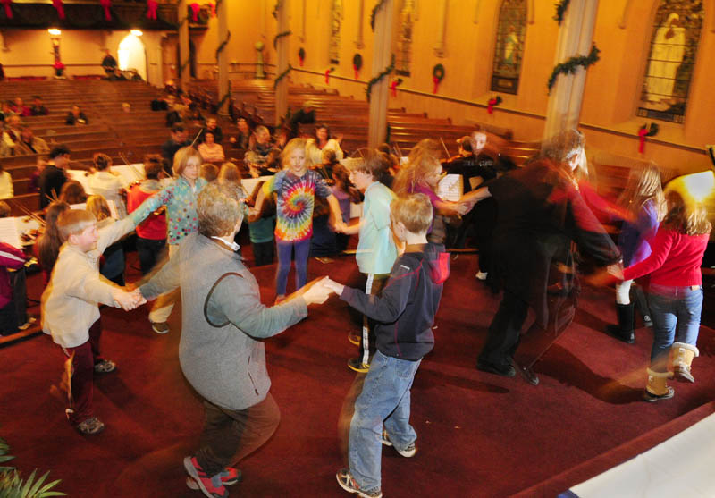 The Pineland Suzuki School rehearses on Friday night at South Parish Congregational Church in Augusta. Their concert will feature singers and dancers, along with the orchestra for a "Lord of The Dance" number.
