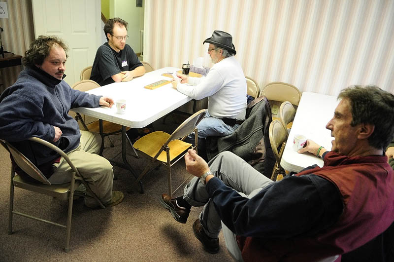 Steven Farrell, far left, chats with weekend manager Will Tibby, far right, as Jarody (who uses only on name), left, and Jim Duling play cribbage on opening day of the Augusta Community Warming Center on Sunday December 16, 2012 in downtown Augusta. The center, located at 44 Front St., across from the gazebo in Augusta's Waterfront Park, is open daily from 9 a.m. to 4 p.m.
